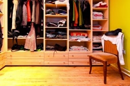 Corner of built in wardrobe with open shelves